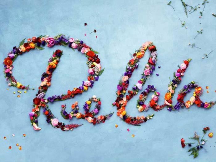 “RueLaLa” spelled out in flower petals on a sky-blue backdrop